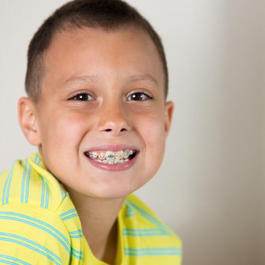 Smiling young boy with braces