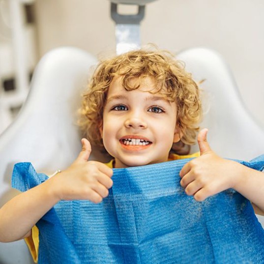 Happy young patient making double thumbs-up gesture