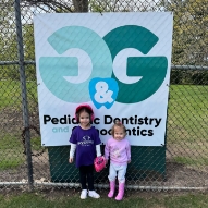 Three young dental patients smiling with cavity free club sign