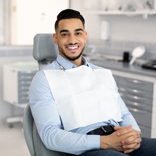 Man smiling while sitting in treatment chair