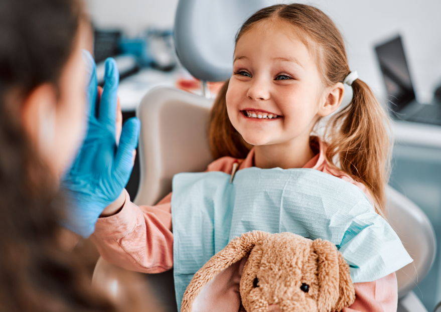 Child high fiving dentist