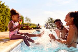 Family playing in a pool